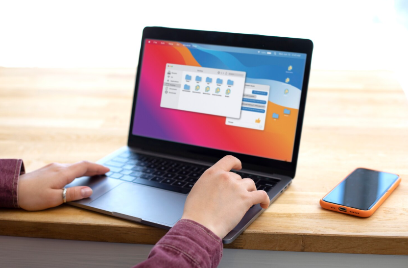 Hands using a laptop to manage system settings while clearing cache and improving device performance.